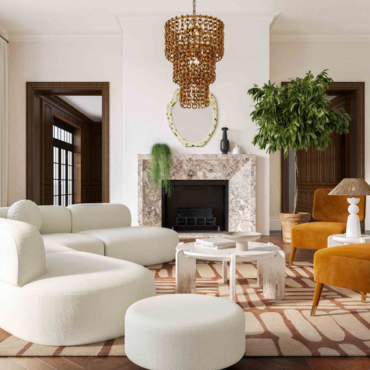 Stylish living room scene featuring white curved sofa, marble fireplace with mirror