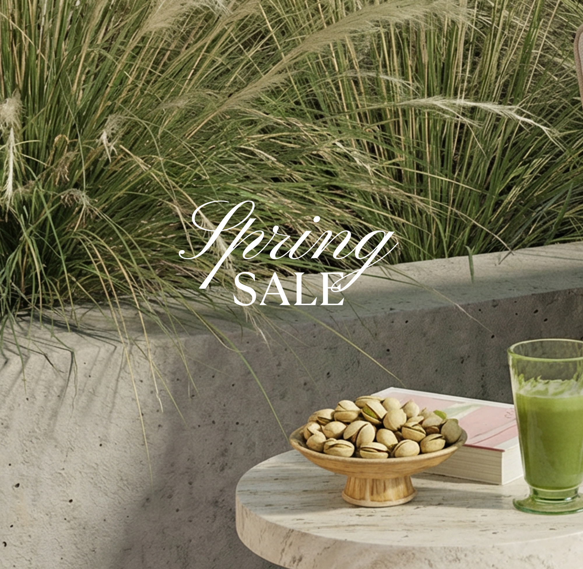 Spring sale text over a table with pistachios and a green drink, surrounded by grass.