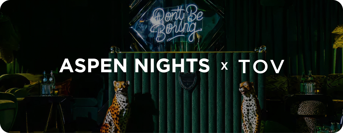 Neon sign with 'Don't Be Boring' and 'ASpen Nights x TOV' text in a dark setting.