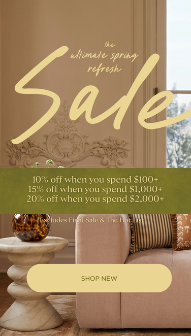 
                Living room with a sofa, coffee table, and wall art, featuring a sale banner in the center.
              